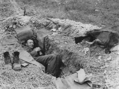 Canadian Soldier Resting in Foxhole in Normandy France 1944