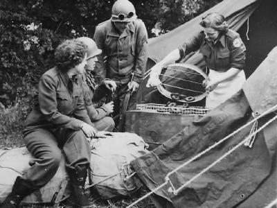 Red Cross girls serves fresh batch of doughnuts to US Army soldiers in Normandy