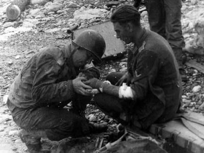 US Medical Officer treats wounded German on Normandy Beach
