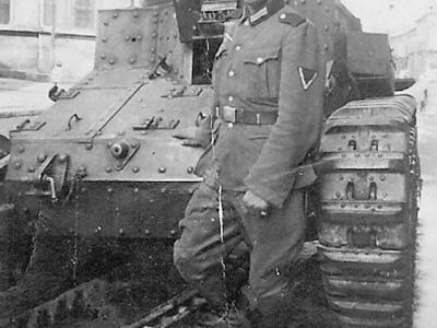 German soldier posing in front of D1 tank
