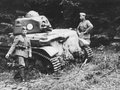 German troops pose next to a captured and damaged Renault R-35 tank