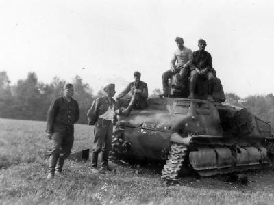 German troops pose next to a captured and damaged Somua S35