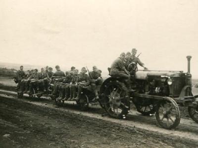 Wehrmacht soldiers riding on a tractor