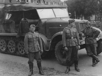 Wehrmacht soldiers posing beside a SdKfz 7 halftrack