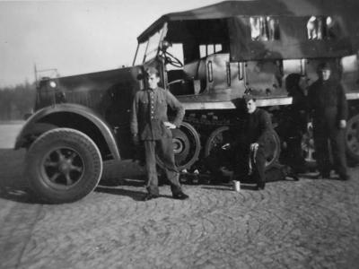 Wehrmacht soldiers next to a SdKfz 7