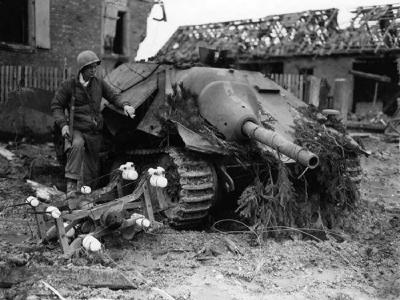 Soldier inspecting destroyed Hetzer