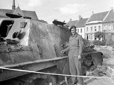Cpl Sid Walker of the County of London Yeomanry, 7th Armoured Division next to a Jagdpanther – Gheel 16 September 1944