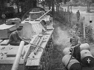 Crew member refueling Panzer III number 112