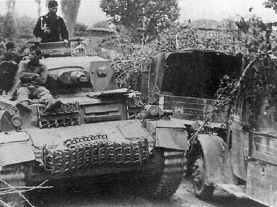 Panzer IV Ausf C passing trucks on road
