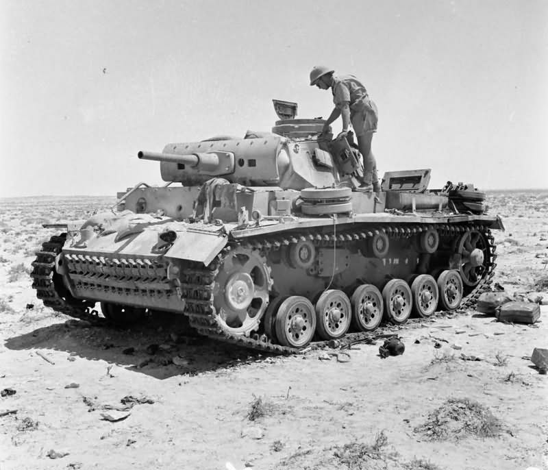 A destroyed Panzer III tank being inspected near Tel el Eissa 4 August 1942