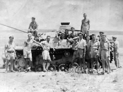 British soldier posing beside a Panzer III Africa
