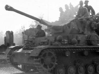 German infantry and tankers ride a Panzer IV