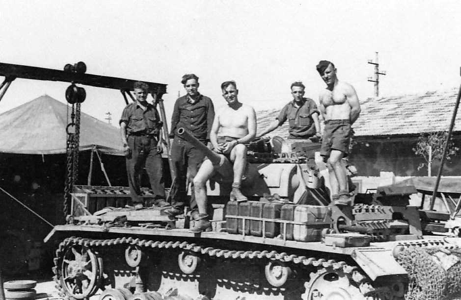 Crew work on a Panzer III tank in a workshop