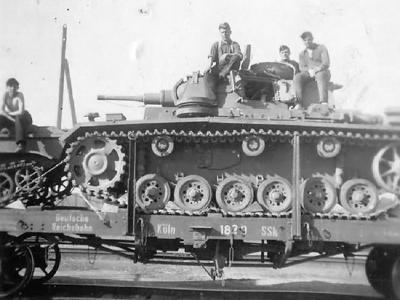 Panzer III on railroad flat car in transit to the front