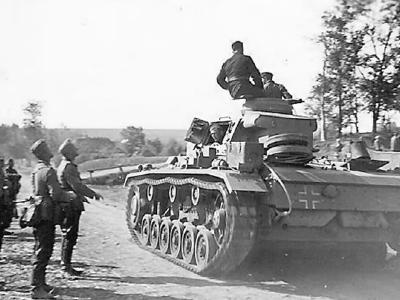 Panzer III passing wehrmacht troops