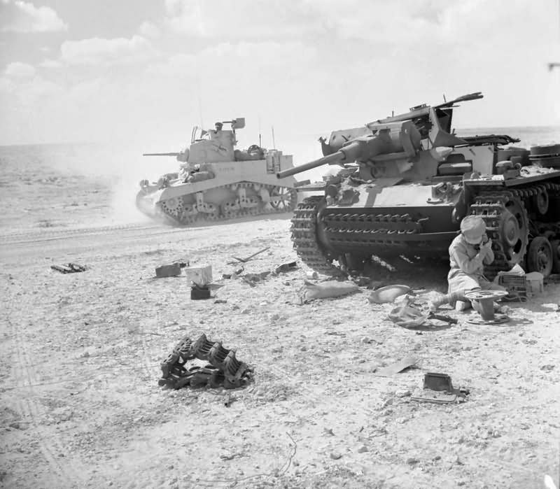 Stuart tank passes by a destroyed German Panzer III November 1942