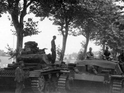 Panzer III is passed by a StuG III