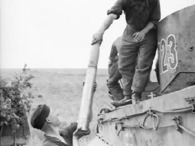 Crew loading ammo into Tiger I tank number 123 of Schwere Panzer Abteilung 503