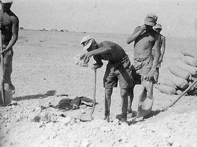 Afrika korps soldiers filling sandbags in desert