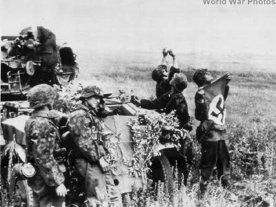 Flak-Kanoniere of the 2 SS-Panzer-Division Das Reich wave a flag to alert the German pilots above them Belgorod 1943