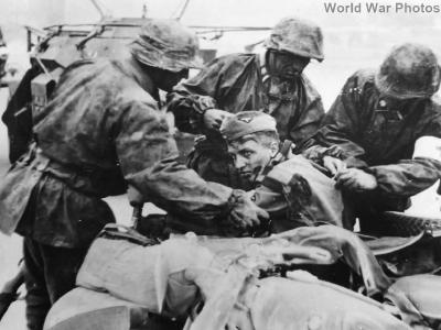 Kradschutze of 3rd SS Totenkopf aid wounded comrade