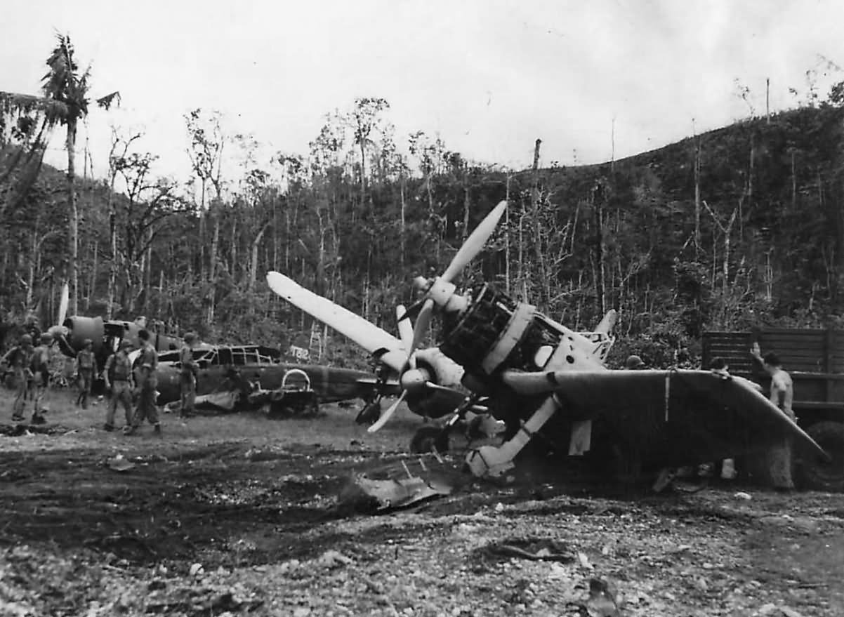 US troops inspect wrecked A6M Zeros and D3A Val at Munda Airport