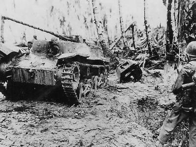 US Troops in jungle with Knocked Out Japanese tank Ha-Go