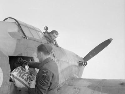RAF sergeant unloads a press bag delivered by Hurricane pilot