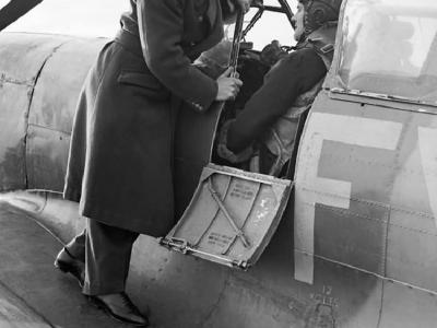 Group Captain A.G. Malan on the wing of Squadron Leader Hugo Armstrong’s Spitfire Mk IX at Biggin Hill, 2 January 1943