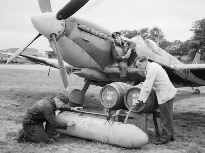 Spitfire’s external fuel tank filled with beer from barrels before being flown to Allied forces in Normandy – June/July 1944