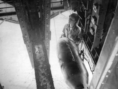 Crew loading bombs onto B-17