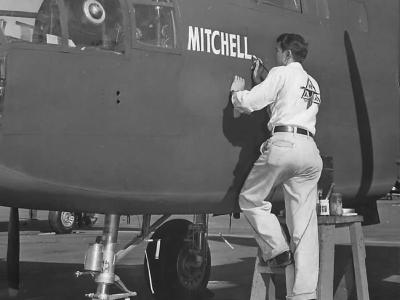 Workman at NAA factory in Inglewood painting General Mitchell’s name on B-25