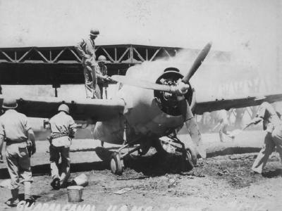 Burning F4F-4 at Henderson Field