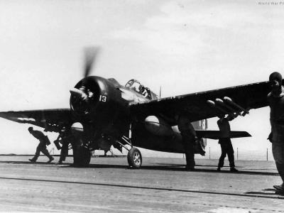 Flight deck crewmen conduct final checks on an FM, Okinawa in April 1945