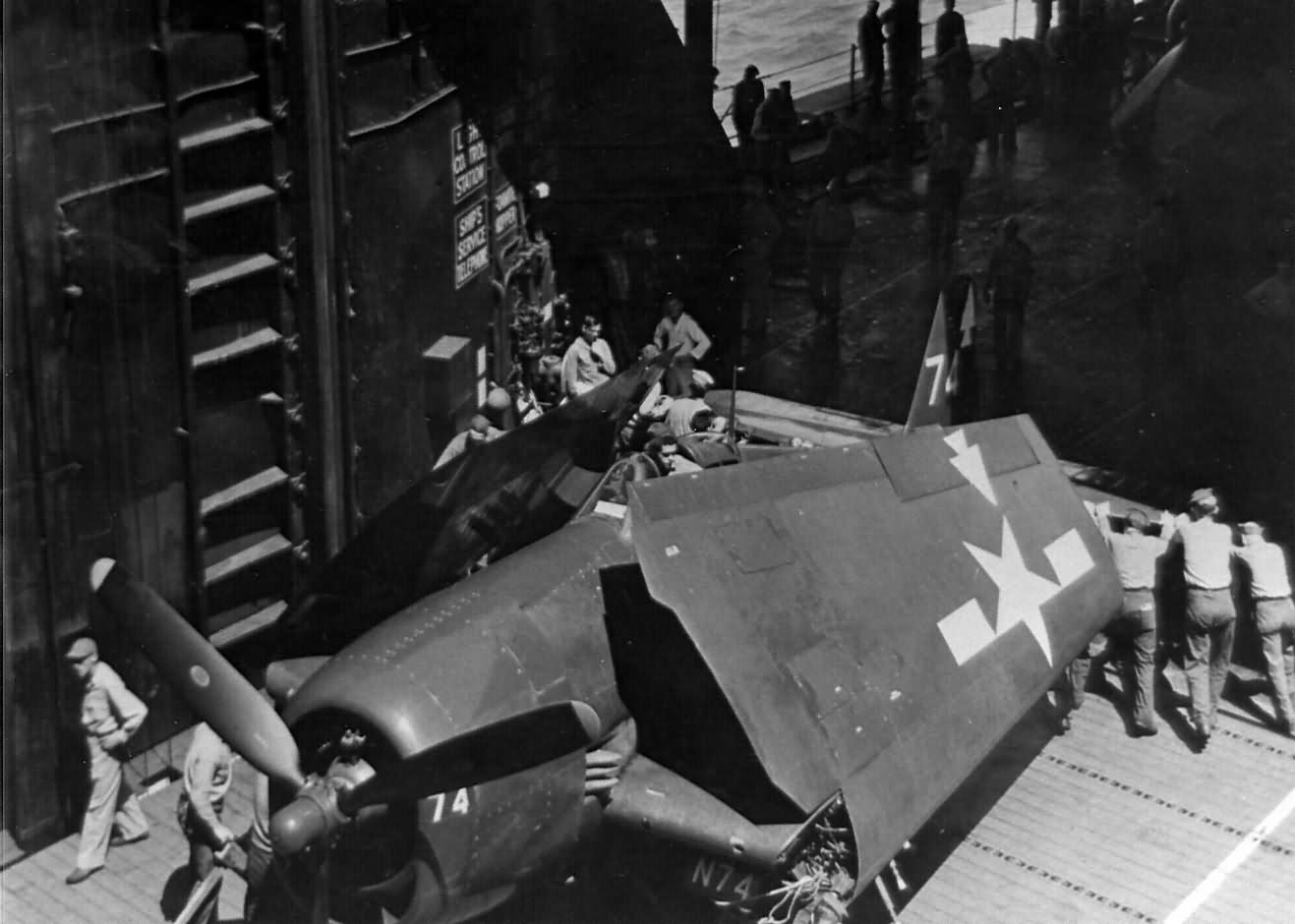 USS Bennington CV-20 crew push F6F-5 #74 of VF-82 – February 1945