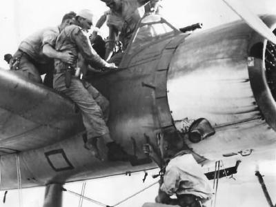 Wounded Airman helped from OS2U after rescue from Pacific 44