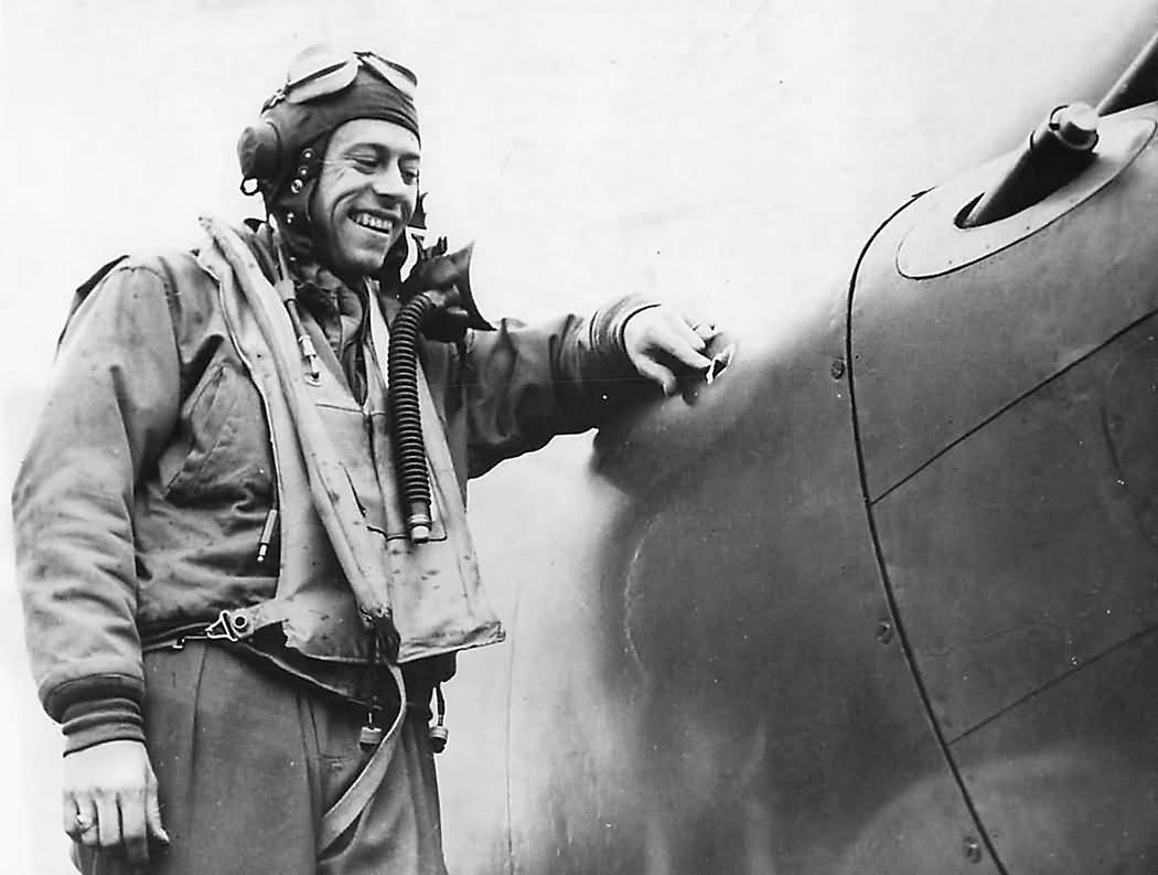 Lt Paul Fisher of the 38th Fighter Squadron 55th Fighter Group checks battle damage to his P-38 1944