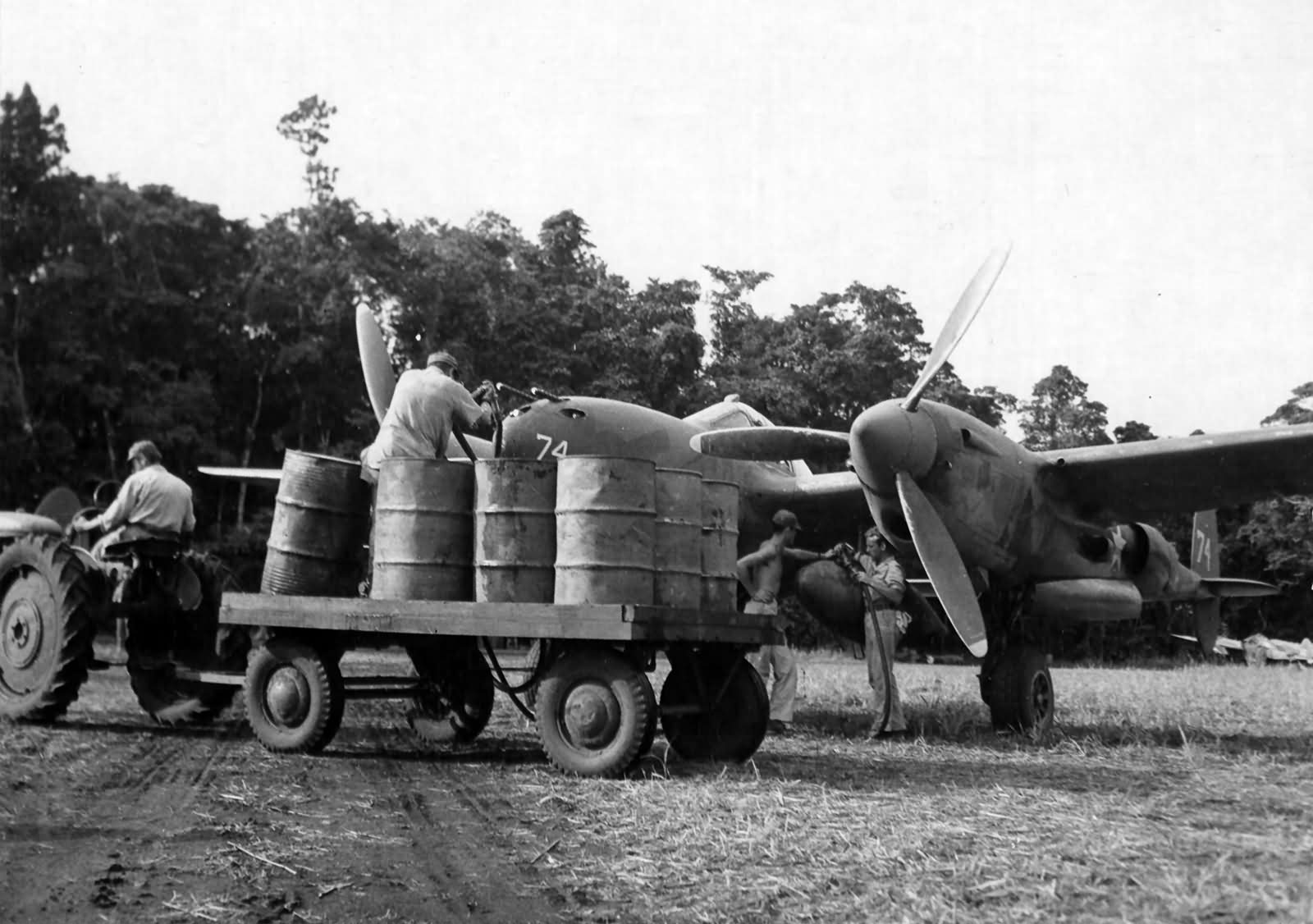 ground crewmen service a P-38 Lightning #74 of the 39th FS 35th Fighter Group, 28 February 1943