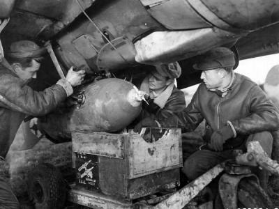 Ground Crew Men Loading A 500lb Bomb On A Curtiss P-40 Warhawk Of The 79th Fighter Group Based At Capodichino Italy