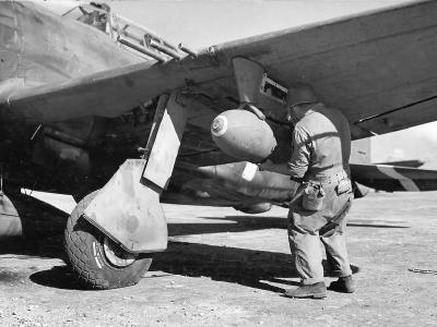 Ground Crewman Loading Bomb Onto P-47 Thunderbolt