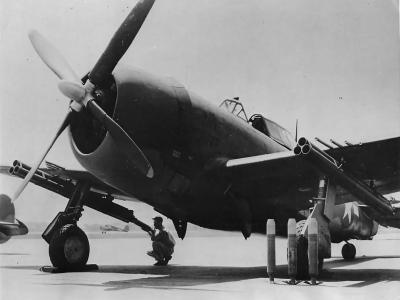 Ground crew loading rockets on P-47 Thunderbolt