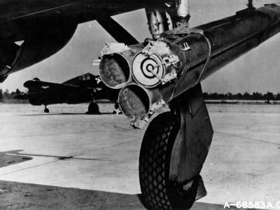P-47 Thunderbolt with bazooka-type triple rocket launchers and P-40 in the background
