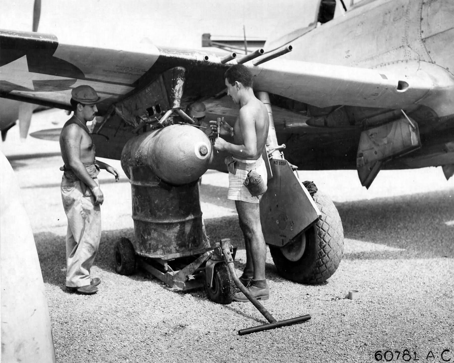 Loading 1000lb bomb on a P-47 of the 201st Mexican FS Porac Airstrip Philippine Islands – 26 June 1945