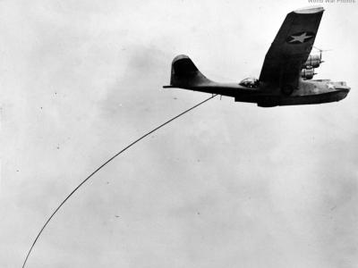 PBY in flight towing the magnetic airborne detector