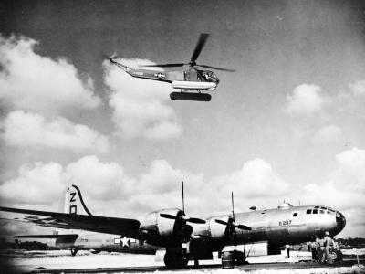 R-4B helicopter hovers over a B-29