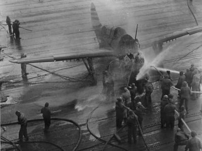 Burning Helldiver after crash landing on USS Randolph