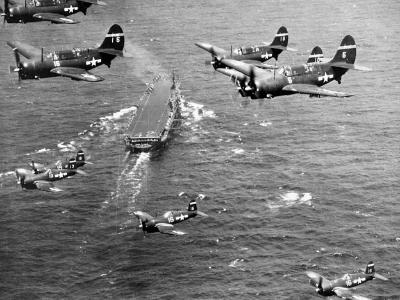SB2C Helldivers and Corsairs in flight over carrier USS Franklin D. Roosevelt (CV-42)