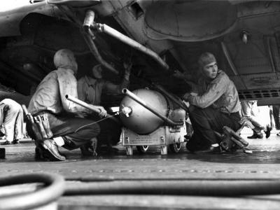 Ordnancemen load a bomb onto an SBD of the VS-6 on board the carrier USS Enterprise invasions of Guadalcanal and Tulagi on August 7, 1942