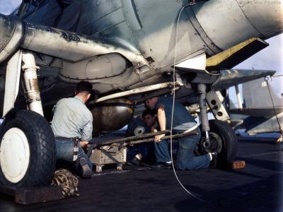 Aviation ordnancemen load bomb