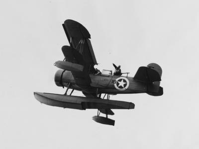 Curtiss SOC #18 drops a message as it flies over USS Augusta (CA-31), North Africa in November 1942